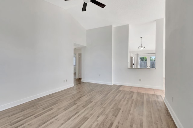 5598 Pebble Brook Ln, Boynton Beach, FL 33472 - unfurnished living room with high vaulted ceiling, light wood-style flooring, baseboards, and a ceiling fan