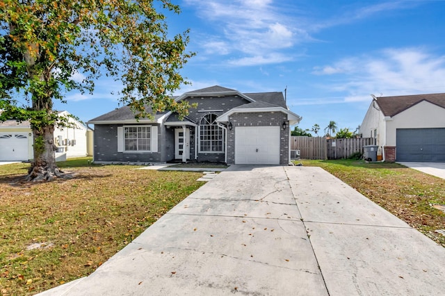 5598 Pebble Brook Ln, Boynton Beach, FL 33472 - single story home with a garage, brick siding, fence, driveway, and a front lawn