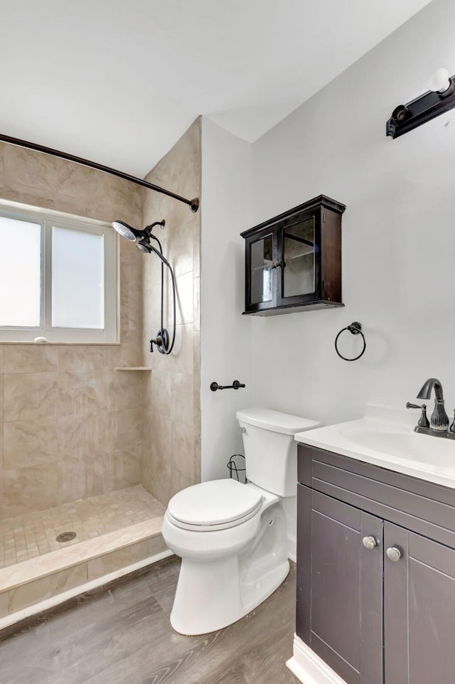 5598 Pebble Brook Ln, Boynton Beach, FL 33472 - bathroom featuring toilet, a stall shower, wood finished floors, and vanity