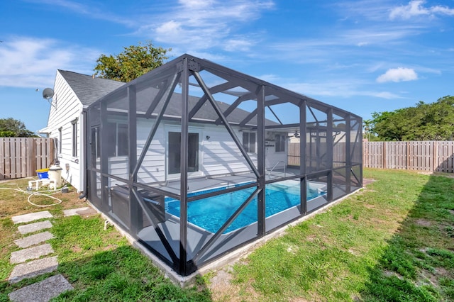 5598 Pebble Brook Ln, Boynton Beach, FL 33472 - view of swimming pool featuring a fenced in pool, a patio, glass enclosure, a fenced backyard, and a yard