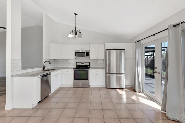5598 Pebble Brook Ln, Boynton Beach, FL 33472 - kitchen with pendant lighting, light countertops, appliances with stainless steel finishes, white cabinets, and a sink