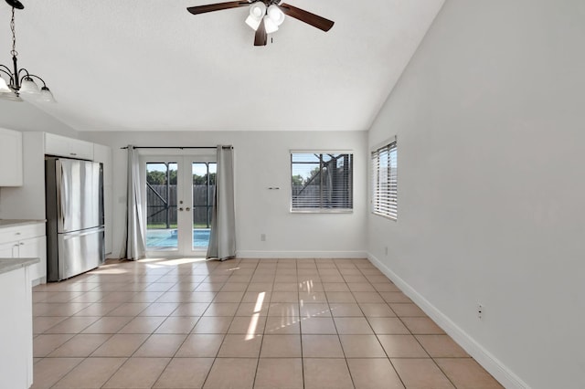 5598 Pebble Brook Ln, Boynton Beach, FL 33472 - spare room featuring french doors, light tile patterned flooring, vaulted ceiling, and baseboards