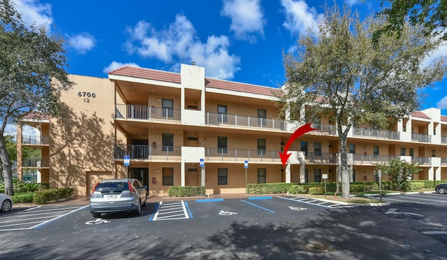 view of property with uncovered parking