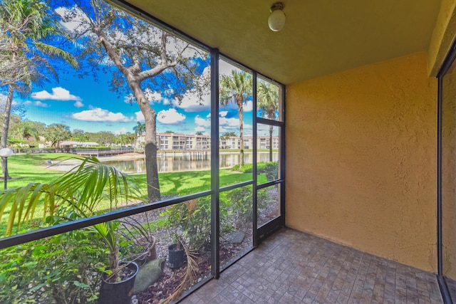 6705 Coral Lake Dr Unit 6705, Margate, FL 33063 - unfurnished sunroom featuring a water view and a textured wall