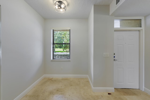 6705 Coral Lake Dr Unit 6705, Margate, FL 33063 - foyer with a textured ceiling and baseboards