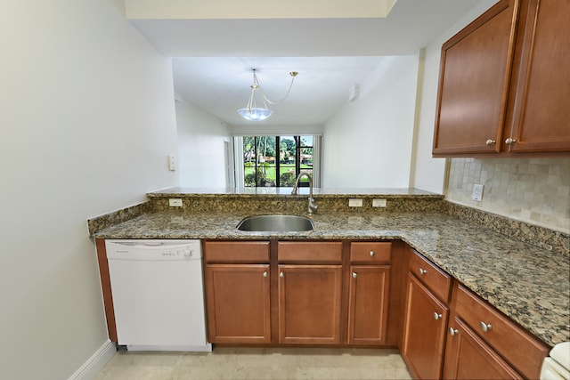 6705 Coral Lake Dr Unit 6705, Margate, FL 33063 - kitchen featuring dishwasher, a sink, dark stone countertops, and a peninsula