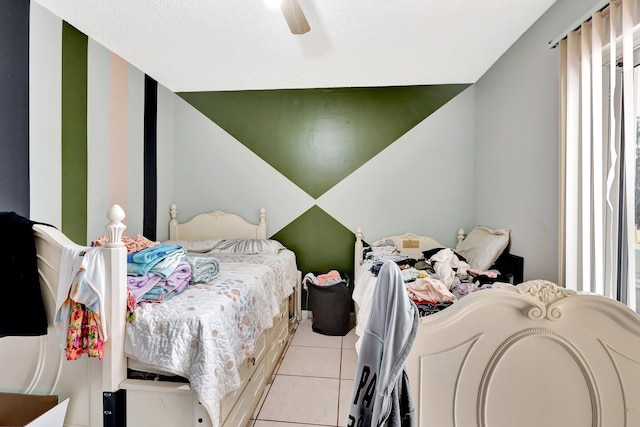 bedroom with a ceiling fan and light tile patterned flooring