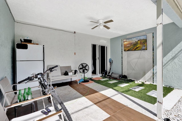 workout area featuring a ceiling fan and wood finished floors