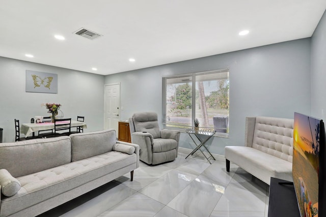 living room with recessed lighting, visible vents, and baseboards