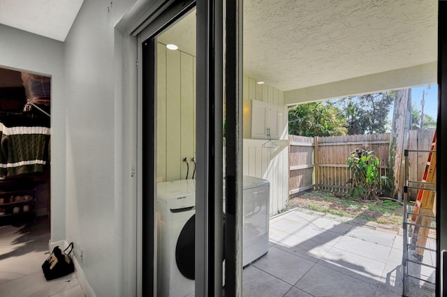 exterior space featuring fence and washer / clothes dryer