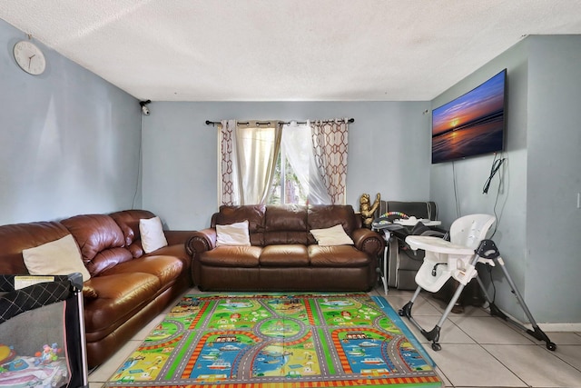 living area with a textured ceiling and light tile patterned floors