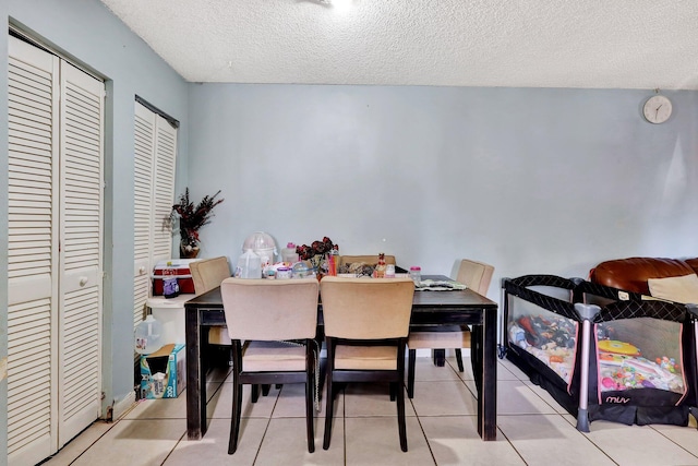 dining room featuring light tile patterned floors and a textured ceiling