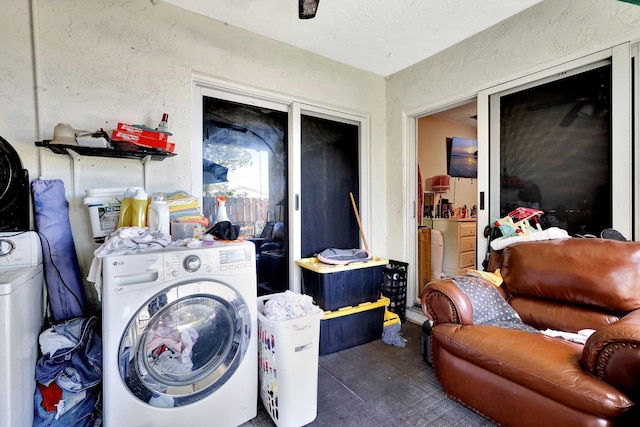 washroom featuring a textured wall and washer / clothes dryer