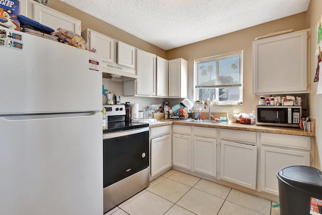 kitchen with white cabinets, stainless steel appliances, and light countertops