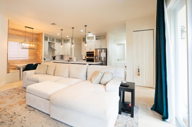 living area with an inviting chandelier, light tile patterned floors, visible vents, and recessed lighting