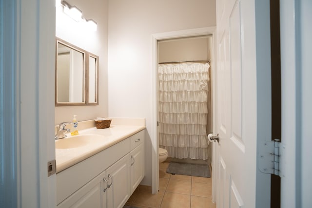 full bathroom featuring a shower with curtain, vanity, toilet, and tile patterned floors