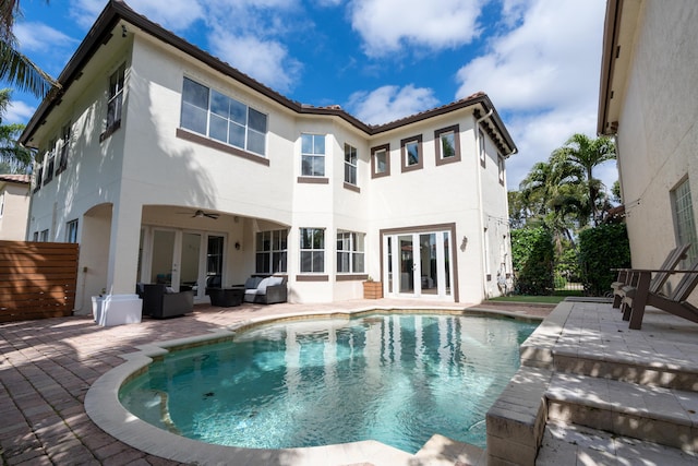 back of property with a patio area, ceiling fan, fence, and french doors