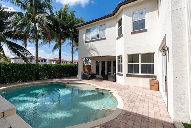 view of swimming pool with a ceiling fan, a fenced in pool, a patio, a fenced backyard, and an outdoor hangout area