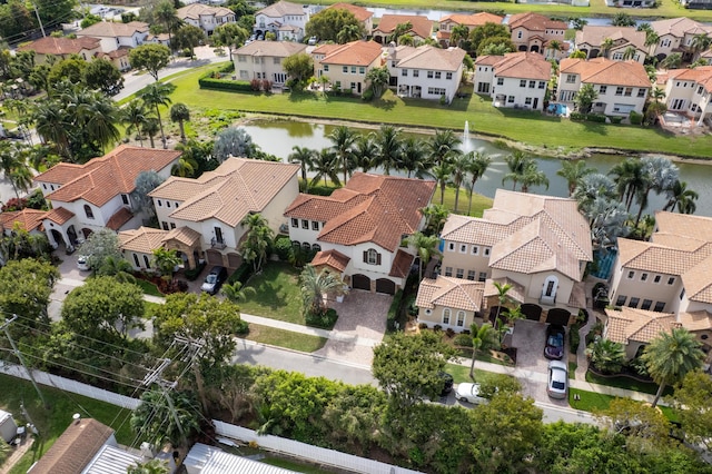 drone / aerial view with a residential view and a water view