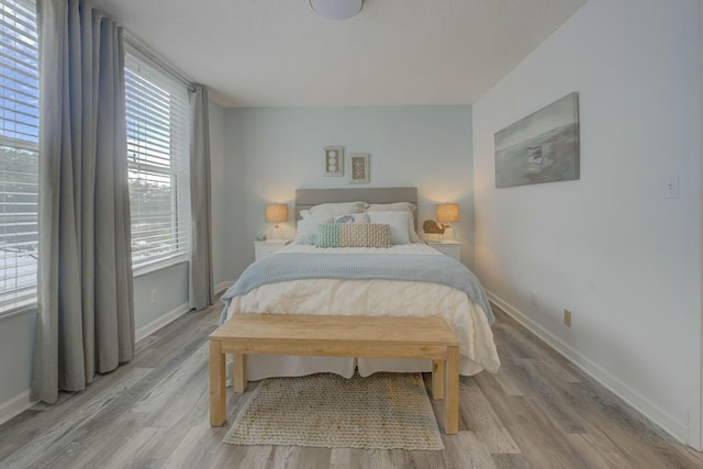 bedroom with baseboards and light wood-style floors