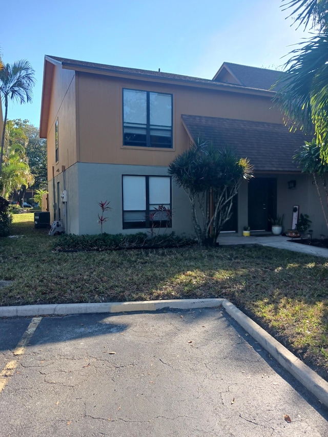 view of front of property with uncovered parking and stucco siding