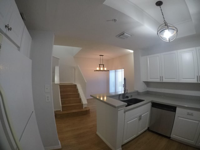 kitchen featuring white cabinetry, dishwasher, a peninsula, and a sink