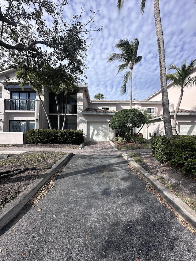 multi unit property with a garage and stucco siding