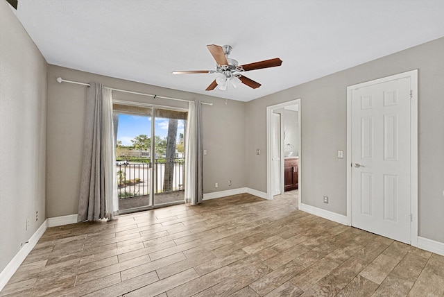 unfurnished room featuring light wood-style flooring, baseboards, and a ceiling fan