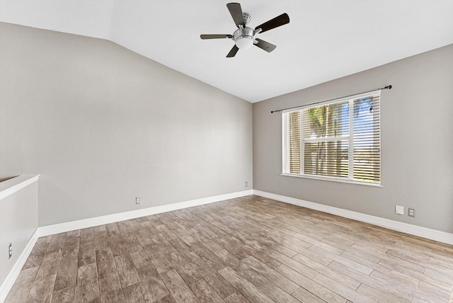 unfurnished room featuring a ceiling fan, lofted ceiling, baseboards, and wood finished floors