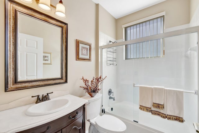 full bath featuring enclosed tub / shower combo, toilet, and vanity