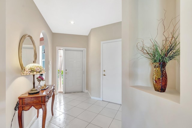 entrance foyer featuring light tile patterned flooring and baseboards