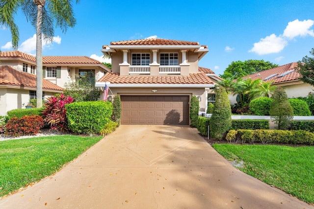 mediterranean / spanish-style house featuring a garage, concrete driveway, a balcony, and stucco siding