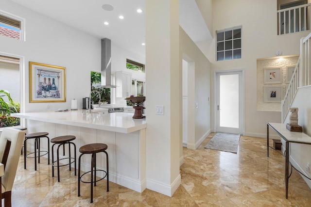 entrance foyer with recessed lighting, baseboards, stairway, and a high ceiling