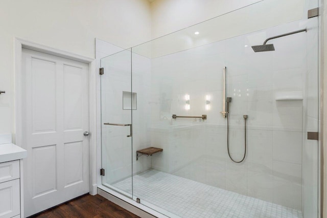 full bath with wood finished floors, a shower stall, and vanity