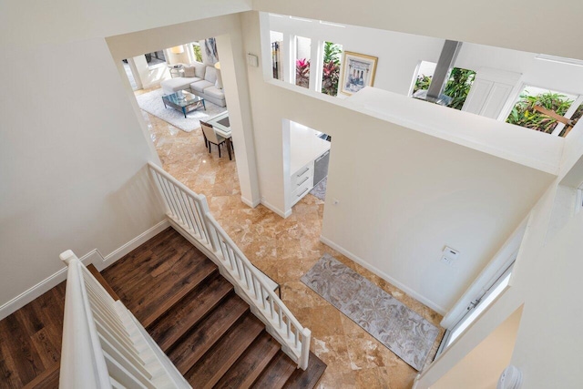 stairs featuring baseboards and wood finished floors