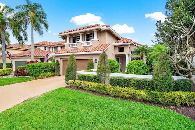 mediterranean / spanish-style home featuring a balcony, concrete driveway, a tiled roof, stucco siding, and a front lawn