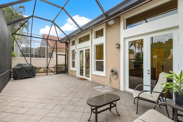 sunroom / solarium featuring french doors