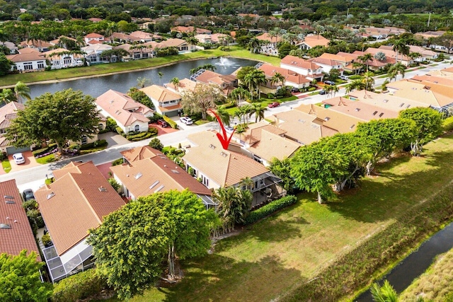 drone / aerial view featuring a residential view and a water view