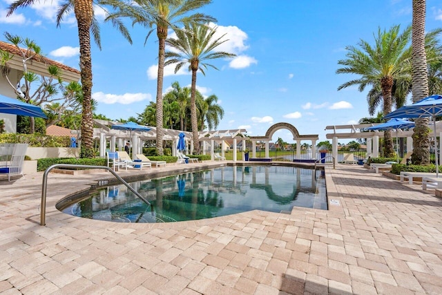 view of swimming pool with a patio and a pergola