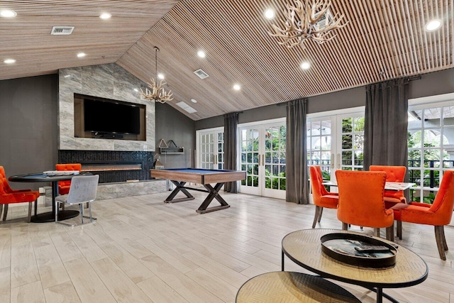 game room with visible vents, wood ceiling, wood finished floors, french doors, and a high end fireplace