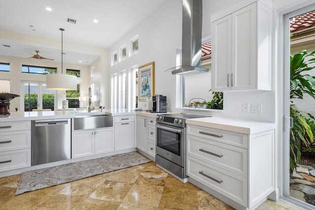 kitchen with visible vents, appliances with stainless steel finishes, white cabinetry, a sink, and exhaust hood