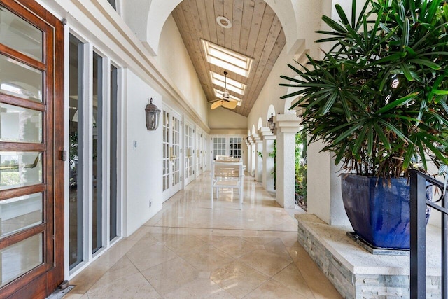 corridor with vaulted ceiling with skylight