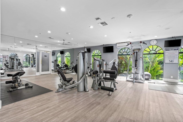 workout area with recessed lighting, visible vents, plenty of natural light, and light wood-style flooring