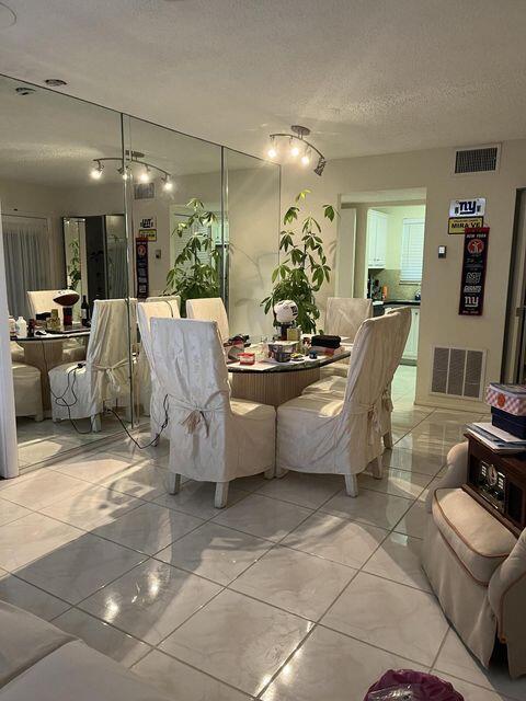 dining room with a textured ceiling and visible vents