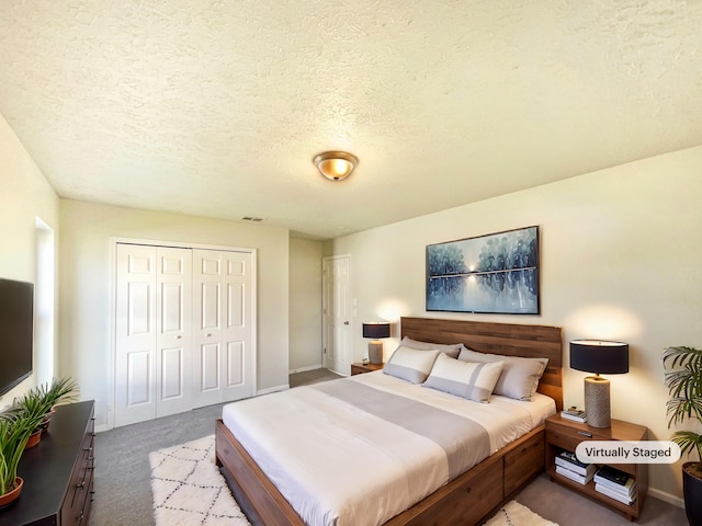 carpeted bedroom with a textured ceiling, a closet, and visible vents