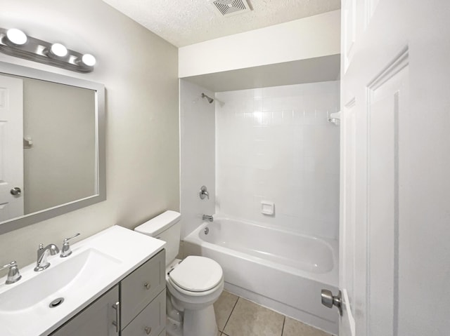 full bathroom featuring a textured ceiling, tile patterned flooring, toilet, vanity, and visible vents