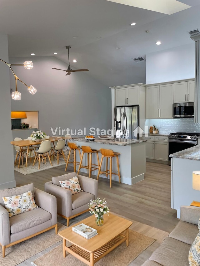 3345 Pine Hill Trl, Palm Beach Gardens, FL 33418 - living area with light wood-style flooring, recessed lighting, high vaulted ceiling, and ceiling fan