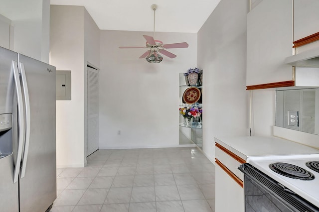 kitchen featuring ceiling fan, white cabinetry, light countertops, electric panel, and stainless steel fridge