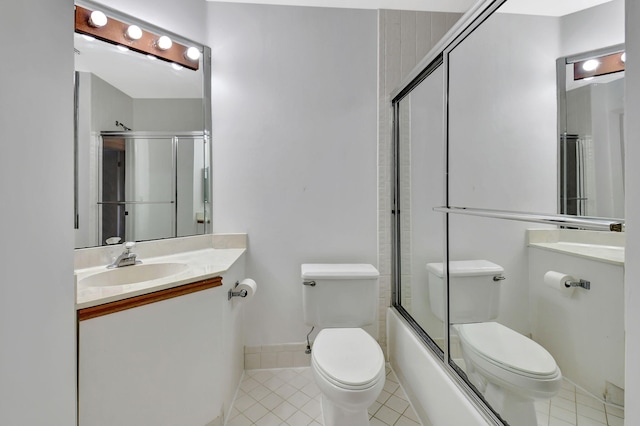 bathroom with toilet, bath / shower combo with glass door, vanity, and tile patterned floors