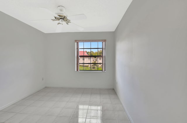 empty room with a ceiling fan and baseboards